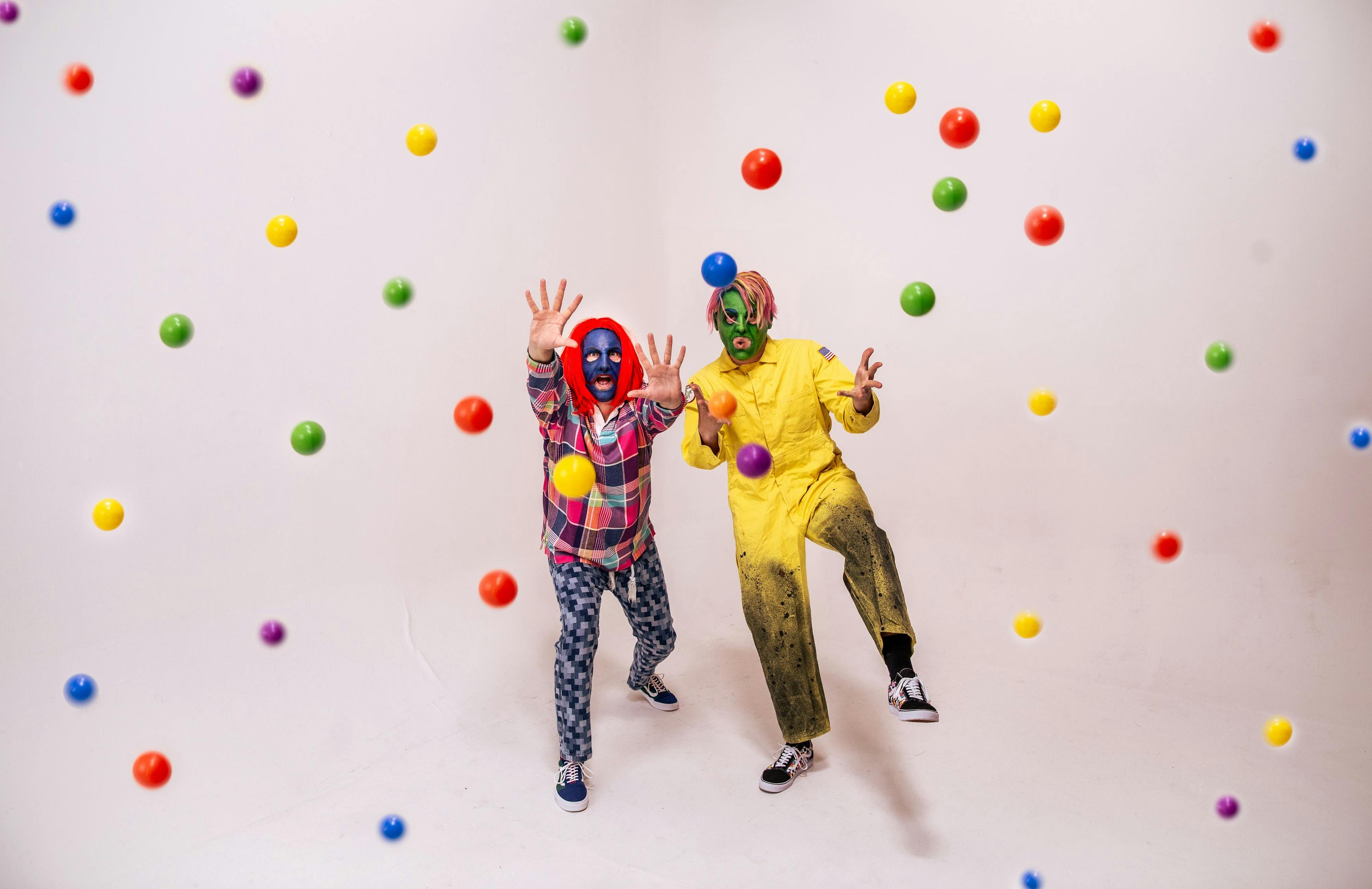 Picture of music duo Confetti throwing colorful plastic balls